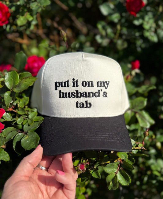 Put it on my husband’s tab Trucker Hat